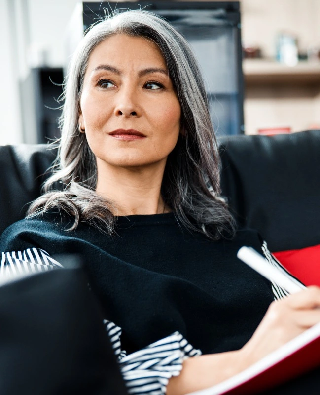 Woman in need of tooth replacement hiding smile