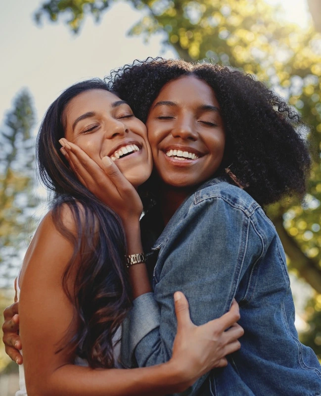 Two women with gorgeous smiles after cosmetic dentistry